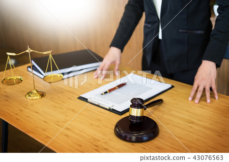 lawyer judge reading documents at desk in courtroom working on w 43076563