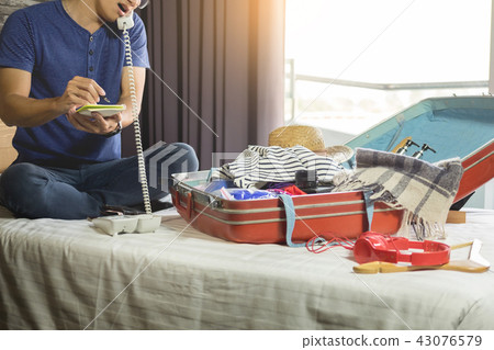 Young man hurring up to meeting and talking by phone and taking Young man hurring up to meeting and talking by phone and taking 43076579