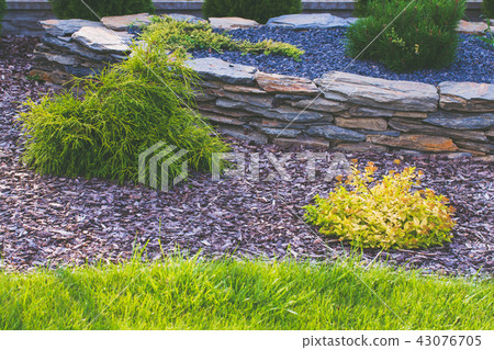Garden lawn and bark in flowerbed. Garden lawn and bark in flowerbed. 43076705