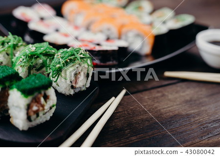Japanese sushi rolls set on plate, selective focus Japanese sushi rolls set on plate, selective focus 43080042