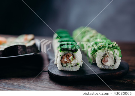 Traditional Japanese sushi rolls on dark plate 43080065