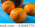 Orange placed on a wooden table 43080770