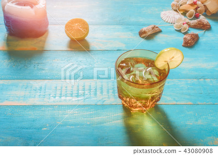 Drinks on the beach, lime soda on the table. Durin 43080908