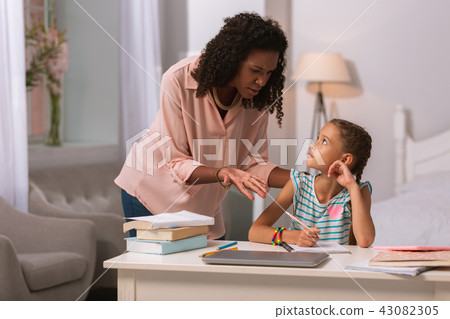 Nice pleasant woman standing near her daughter 43082305