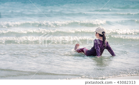 little Asian girl run play waves on the beach little Asian girl run play waves on the beach 43082313