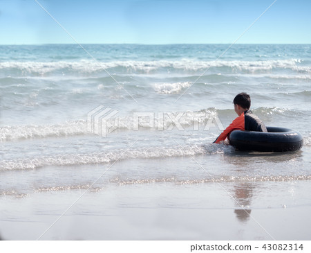 little Asian boy play waves on the beach little Asian boy play waves on the beach 43082314
