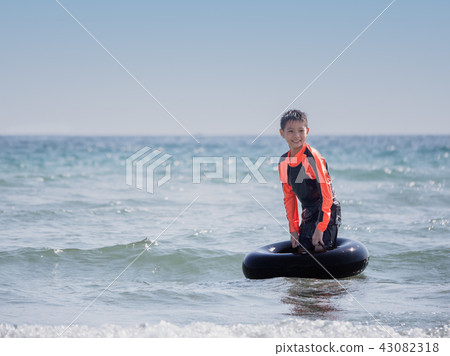 little Asian boy play waves on the beach little Asian boy play waves on the beach 43082318