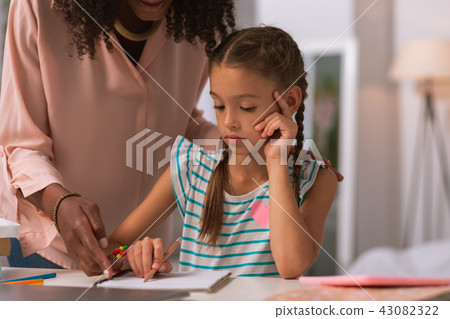 Smart serious girl listening to her mothers explanation Smart serious girl listening to her mothers explanation 43082322