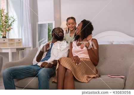Happy joyful family sitting together on the sofa 43083056