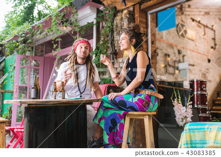 Dark-haired woman celebrating birthday with her hippie boyfriend Dark-haired woman celebrating birthday with her hippie boyfriend 43083385