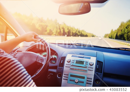 driver driving a car on asphalt road in summer 43083552