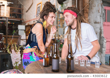 Dark-haired hippie woman wearing bright yellow earrings 43083612