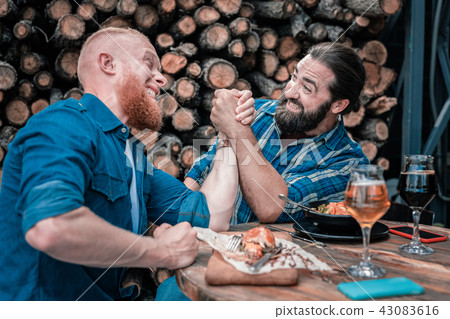 Two beaming mature men having fun while drinking beer Two beaming mature men having fun while drinking beer 43083616