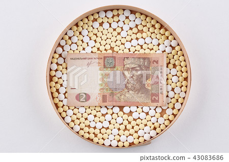 Pills in wooden box with ukrainian hryvnia bank Pills in wooden box with ukrainian hryvnia bank 43083686