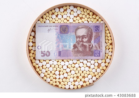 Pills in wooden box with ukrainian hryvnia bank Pills in wooden box with ukrainian hryvnia bank 43083688