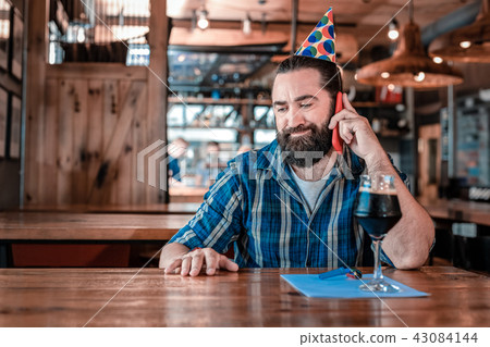 Birthday man feeling unsatisfied while sitting alone in the bar Birthday man feeling unsatisfied while sitting alone in the bar 43084144
