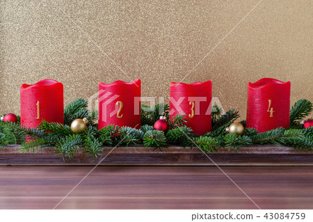 traditional red advent candles with numbers and branch of fir with christmas baubles on gold 43084759