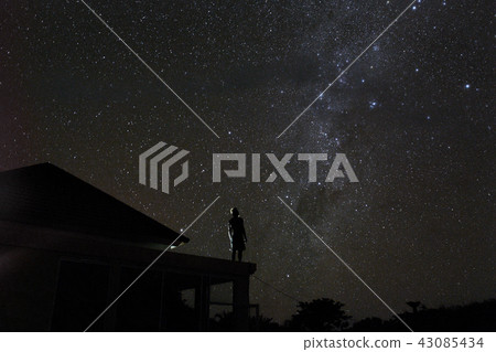 alone woman on rooftop watching mliky way and stars in the night sky on Bali island 43085434