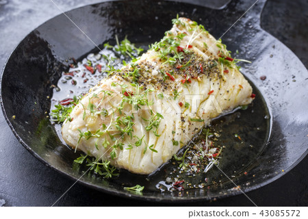 cod fish fillet with spice and cress  43085572
