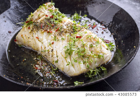 Fried cod fish fillet with spice and cress 43085573