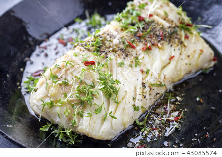 Fried cod fish fillet with spice and cress 43085574