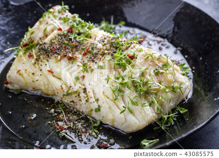 Fried cod fish fillet with spice and cress Fried cod fish fillet with spice and cress 43085575