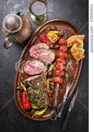 Lamb Roast with skewered tomatoes 43085603