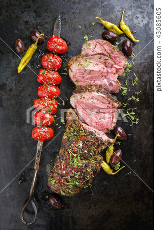 Barbecue Lamb Roast with skewered tomatoes Barbecue Lamb Roast with skewered tomatoes 43085605
