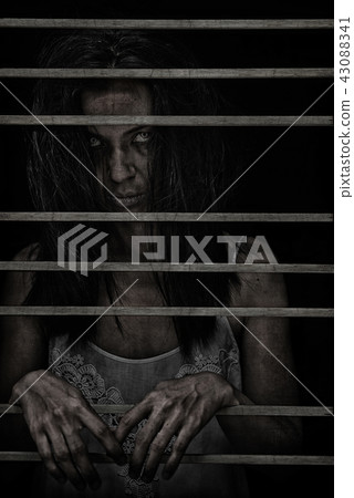 Horror Scene of Possessed Woman ghost in dark cage 43088341