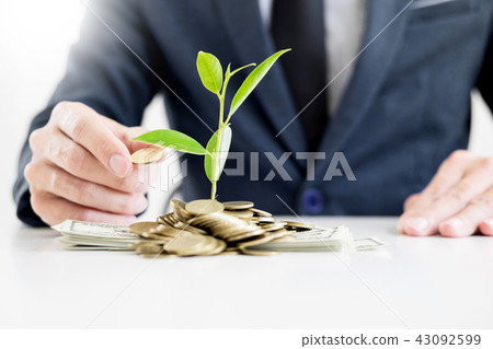 Business man hand make palm up with growing up money coins and s Business man hand make palm up with growing up money coins and s 43092599