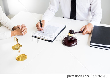 business people and lawyers discussing contract papers sitting a 43092610
