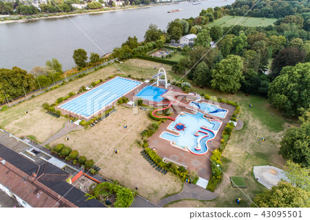Aerial view of empty open-air swimming pool in Germany with no people beside the rhine river in Bonn Aerial view of empty open-air swimming pool in Germany with no people beside the rhine river in Bonn 43095501