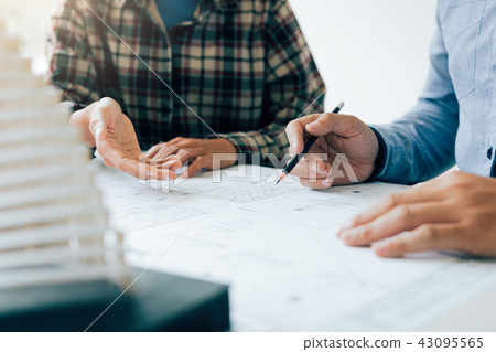 Investor man showing blueprint detail for people Investor man showing blueprint detail for people 43095565