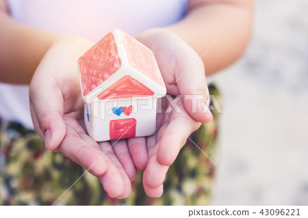 Small kid hands holding house 43096221