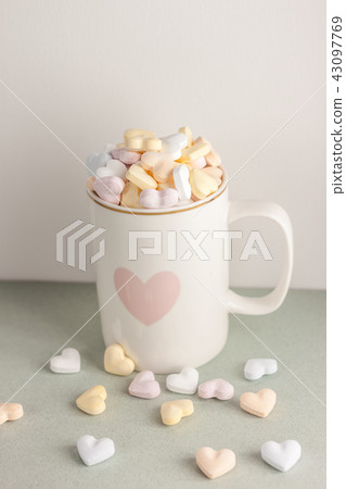 one white cup full of candy hearts 43097769