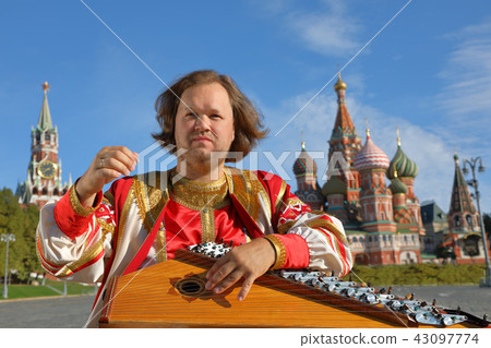 Portrait of a musician with music instrument gusli Portrait of a musician with music instrument gusli 43097774