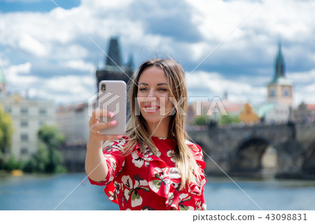girl in red dress make a selfie in Prague girl in red dress make a selfie in Prague 43098831