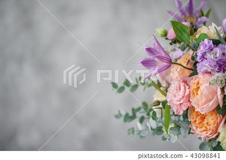Gorgeous bouquet of different flowers. floral arrangement in vintage metal vase. table setting 43098841