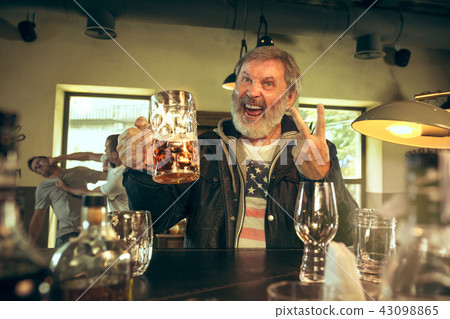 The senior bearded male drinking beer in pub The senior bearded male drinking beer in pub 43098865