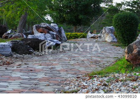 Stone block walkway path in park and light sunset  43099810