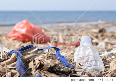 Plastic Waste and Trash on Sandy Beach. Environmental Pollution Problem Concept. 43100023