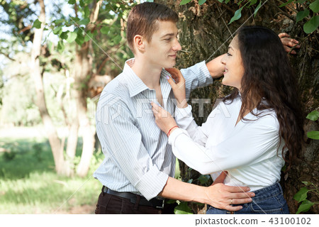young couple walking in the forest, summer nature young couple walking in the forest, summer nature 43100102
