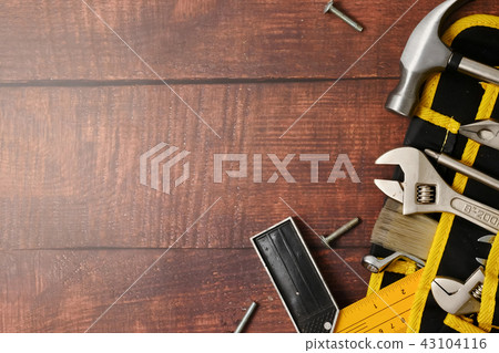 Construction worker belt with tools on wooden table background. Construction worker belt with tools on wooden table background. 43104116
