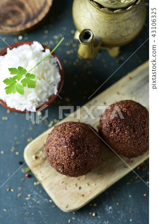 kibbeh, a levantine dish, on a rustic wooden table 43106325