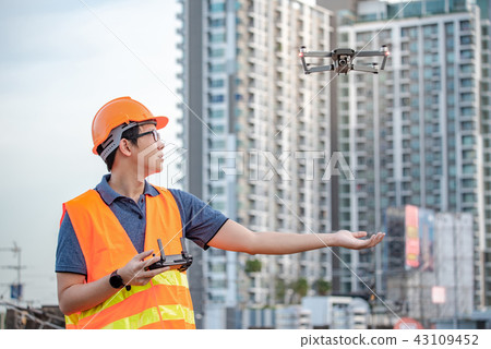 Asian engineer flying drone over construction site Asian engineer flying drone over construction site 43109452