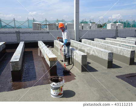 Waterproofing layer applied by construction worker Waterproofing layer applied by construction worker 43111215