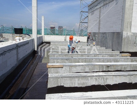 Waterproofing layer applied by construction worker Waterproofing layer applied by construction worker 43111225