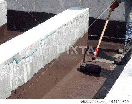 Waterproofing layer applied by construction worker Waterproofing layer applied by construction worker 43111239