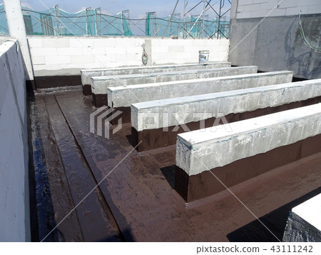Waterproofing layer applied by construction worker Waterproofing layer applied by construction worker 43111242