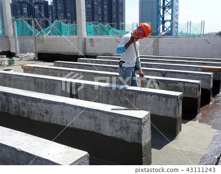 Waterproofing layer applied by construction worker Waterproofing layer applied by construction worker 43111243
